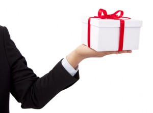 Businessman holding and offer  a gift