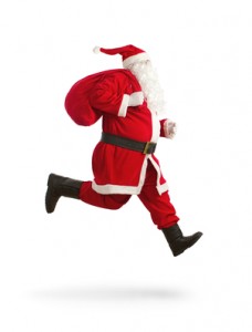 Santa Claus on the run to delivery christmas gifts isolated on w
