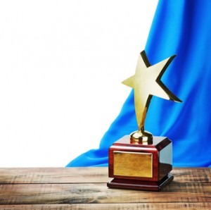 Star award wooden table and on the background of blue curtain