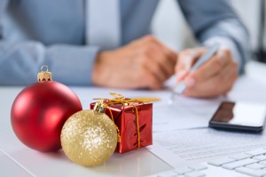 Christmas Ornament In Front Of Businessman Working At Desk