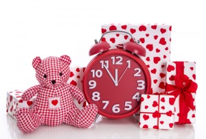 Christmas: red and white presents with clock and  pink teddy bear on white background - last minute shopping